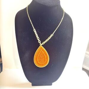 Plunder gold tone wooden beaded tear drop pendant